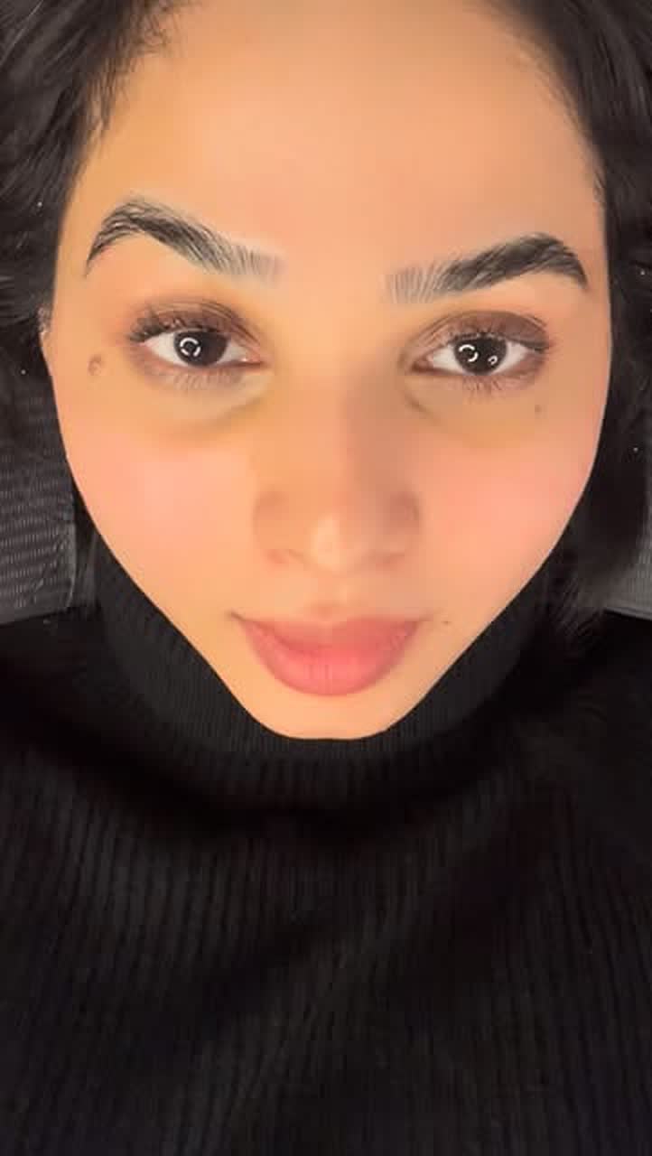 Client showing finished ombré brows, lash lift and lip blush